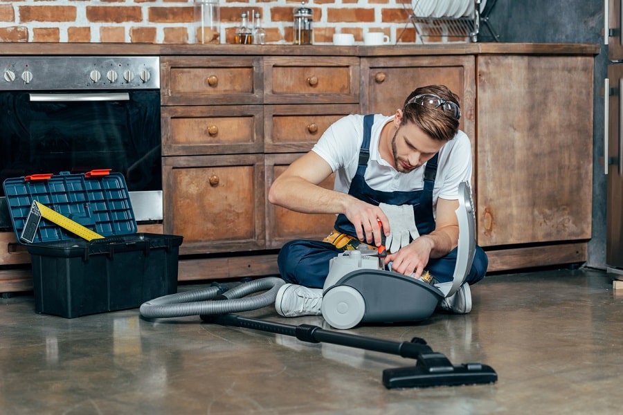 Technician repairing vacuum cleaner